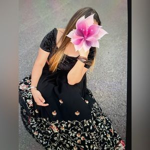 Black lengha with golden and red embroidery.